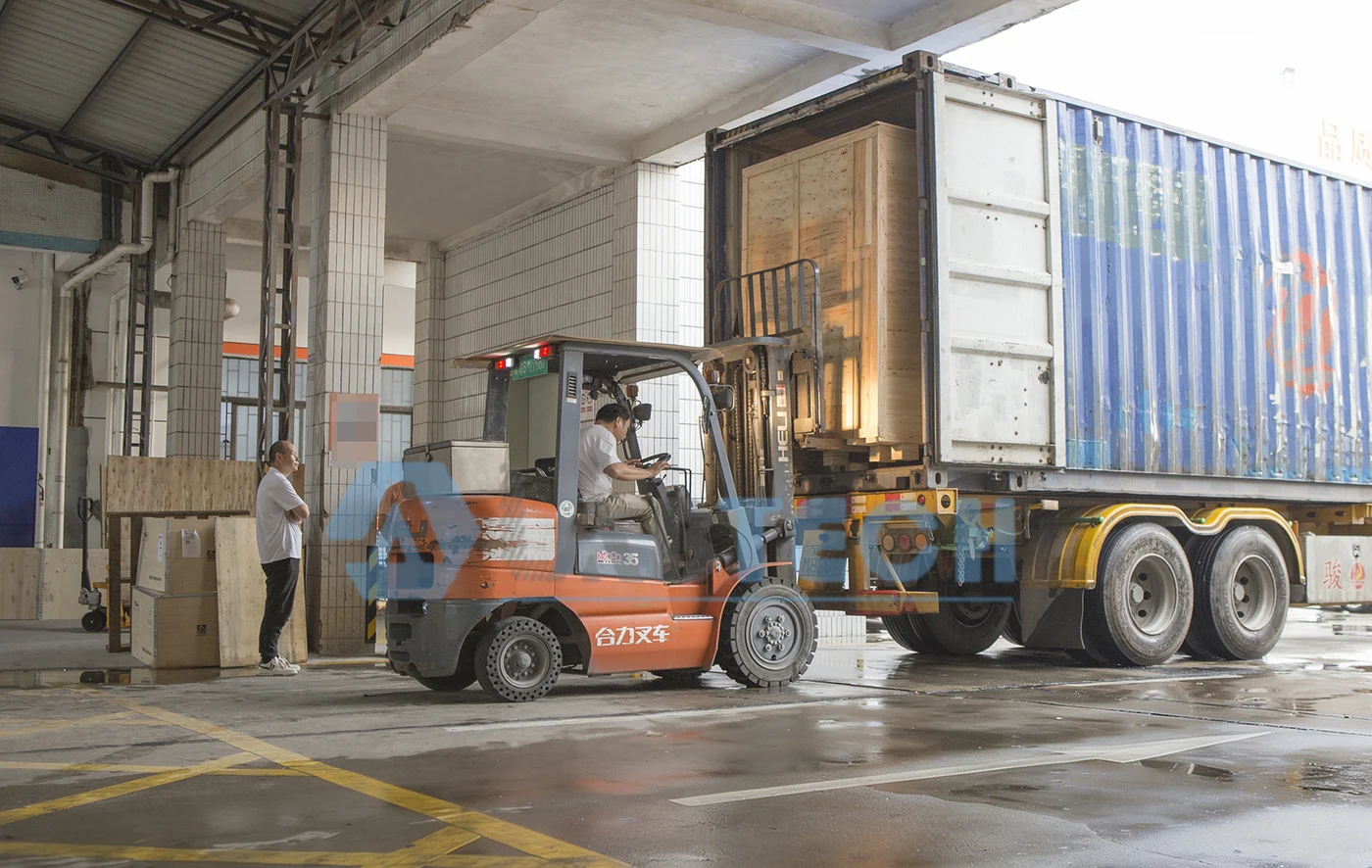 Forklift loading a wooden equipment crate into a shipping container at LABTECH